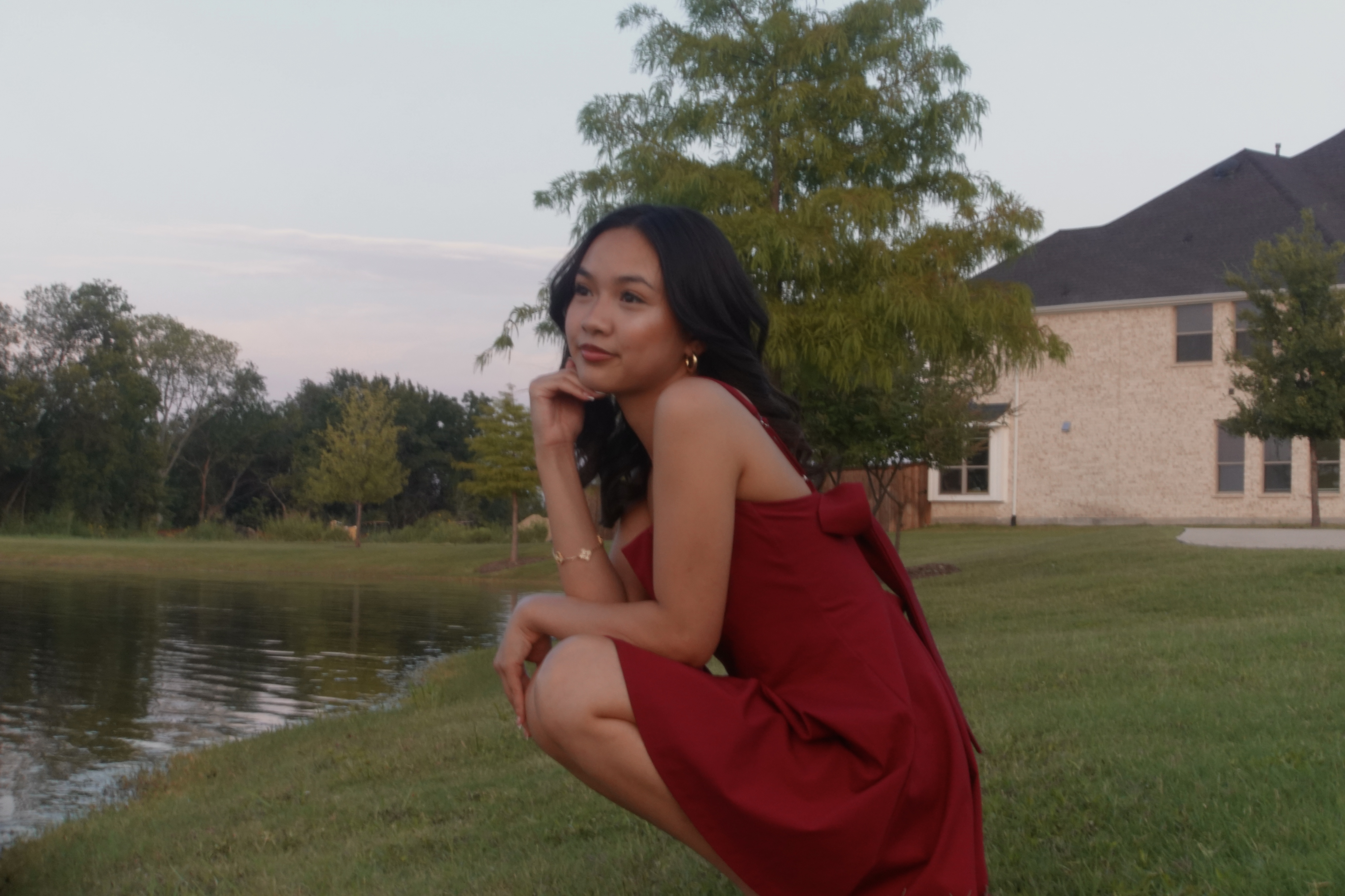 Portrait session by the water in a red dress
