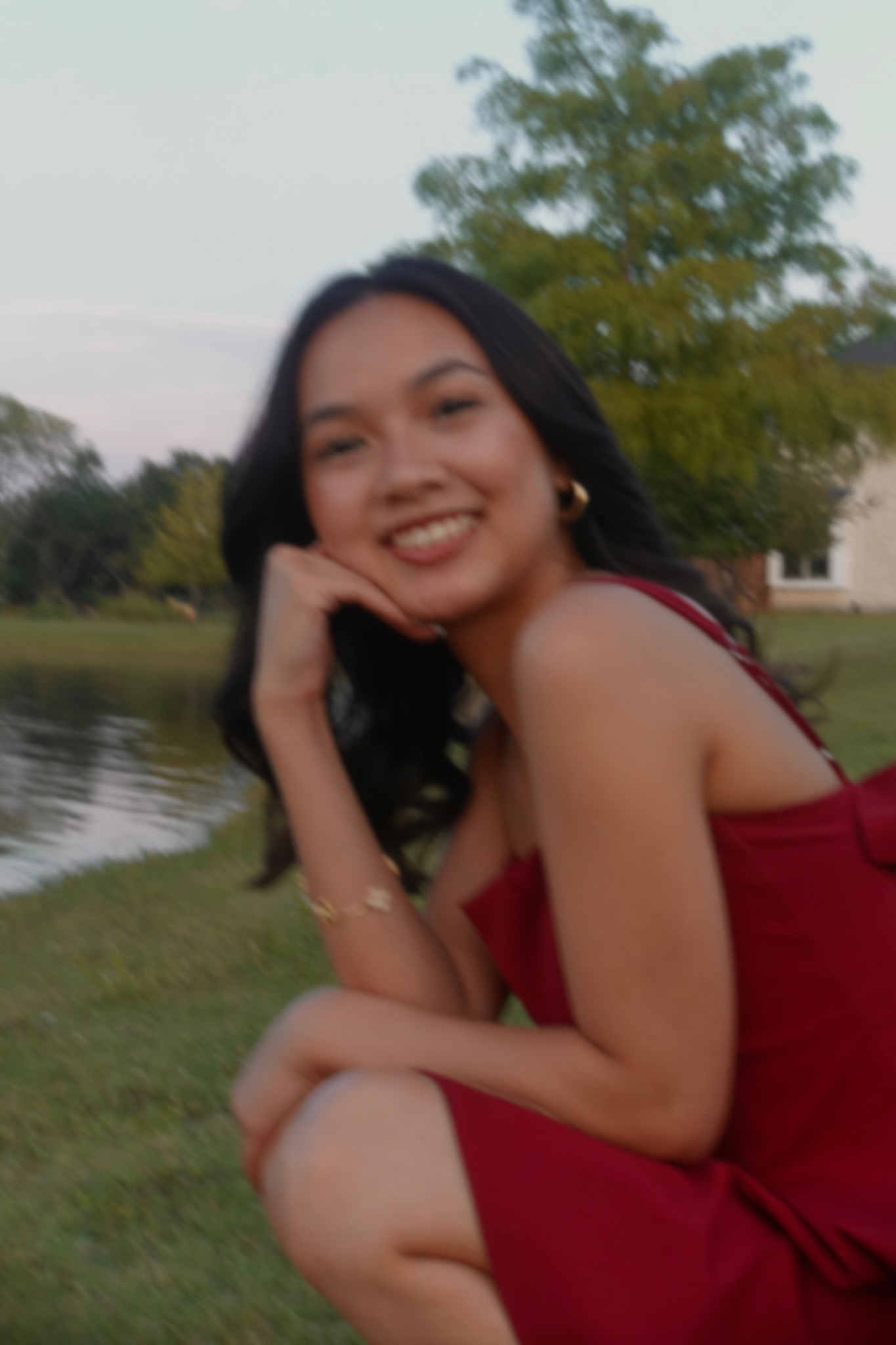 Close-up portrait in a red dress by the water